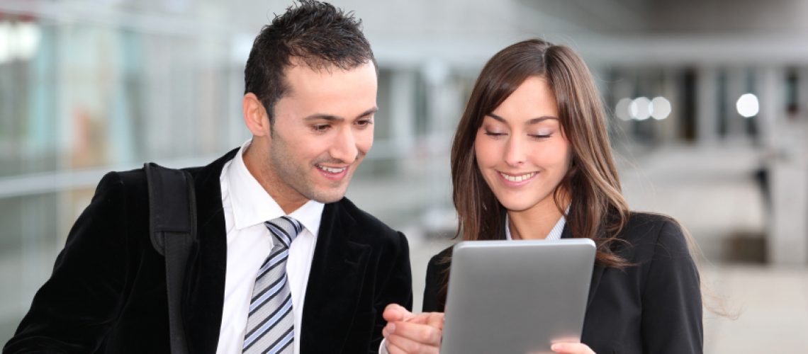 Business people meeting outside with electronic tablet